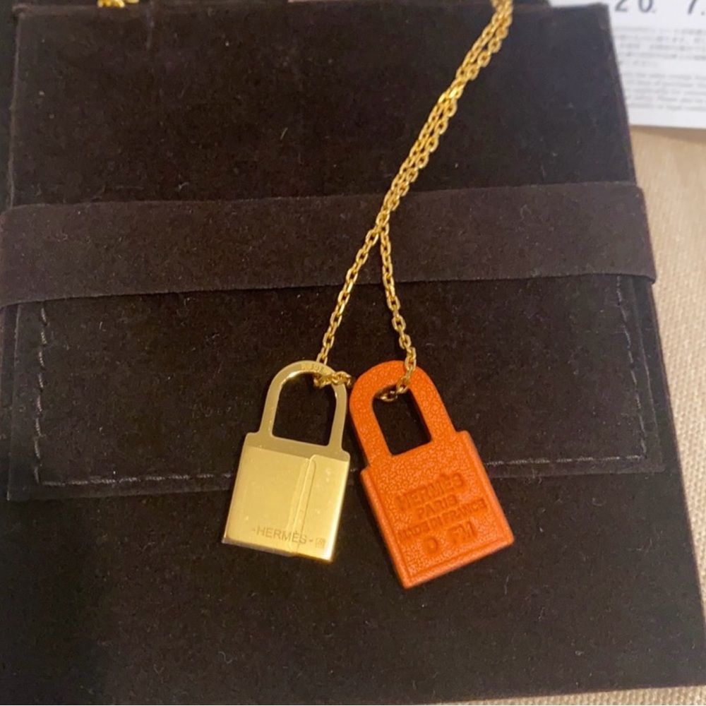 Hermès O’Kelly necklace; Gold with Orange Padlock Charm
